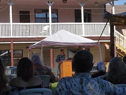 Photo of Stefan Warner speaking at the memorial