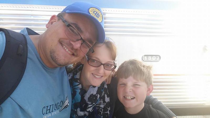 picture of my family (me, wife and stepson) standing in front of an Amtrak train