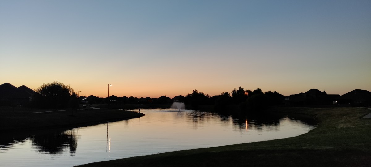 picture of a small lake/pond at sunset
